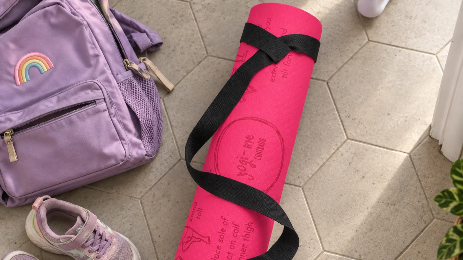 A rolled pink Yogi-Me mat, a backpack and shoes dropped by the front door